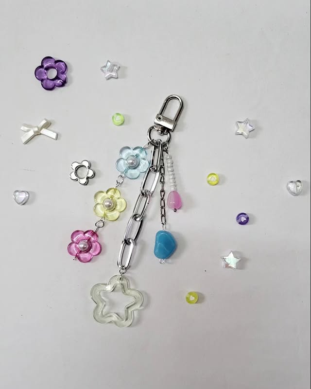 Pastel flower phone charm flat lay